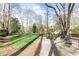 Backyard with a stone fire pit and outdoor seating, framed by lush trees and landscaping at 3605 Wood Valley Ne Ct, Brookhaven, GA 30319