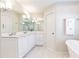 Luxurious bathroom with double vanity, soaking tub, and pristine finishes provides a relaxing and functional space at 3605 Wood Valley Ne Ct, Brookhaven, GA 30319