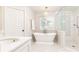 Bright bathroom boasts a soaking tub, walk-in shower, and chic fixtures, perfect for unwinding in style at 3605 Wood Valley Ne Ct, Brookhaven, GA 30319