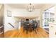 Well-lit breakfast nook open to the staircase featuring a glass table and four chairs at 3605 Wood Valley Ne Ct, Brookhaven, GA 30319
