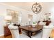 Elegant dining room featuring a large table, upholstered chairs, and modern lighting at 3605 Wood Valley Ne Ct, Brookhaven, GA 30319