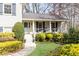 Inviting covered front porch with a decorative door and charming landscaping at 3605 Wood Valley Ne Ct, Brookhaven, GA 30319