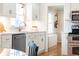 Bright kitchen featuring stainless steel appliances, white cabinets, and hardwood floors at 3605 Wood Valley Ne Ct, Brookhaven, GA 30319