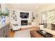 Living area with a fireplace, built-in bookshelves, and hardwood flooring at 3605 Wood Valley Ne Ct, Brookhaven, GA 30319