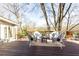 Inviting outdoor patio featuring wicker seating, a coffee table, and serene views of the landscape at 3605 Wood Valley Ne Ct, Brookhaven, GA 30319