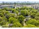 An aerial view of a neighborhood surrounded by lush greenery in an urban location with a clear blue sky at 966 Tilden Nw St, Atlanta, GA 30318