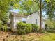 Exterior shot of a home's backyard with green grass, mature trees, and manicured bushes at 966 Tilden Nw St, Atlanta, GA 30318