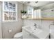 Bright bathroom with white tile, modern sink, and window with blinds at 966 Tilden Nw St, Atlanta, GA 30318