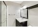 This sleek bathroom offers a modern vanity with a black frame mirror and glass-enclosed shower at 966 Tilden Nw St, Atlanta, GA 30318