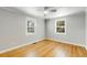 Empty bedroom with wood floors, white trim, ceiling fan and two windows at 966 Tilden Nw St, Atlanta, GA 30318