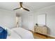 Bright bedroom with ceiling fan, wood floors, storage cabinet, and closet at 966 Tilden Nw St, Atlanta, GA 30318