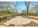 Inviting outdoor common area featuring a patio, picnic table, and a bench with stone accents near a small playground at 966 Tilden Nw St, Atlanta, GA 30318