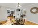 Chic dining area with modern chandelier and access to kitchen and living room at 966 Tilden Nw St, Atlanta, GA 30318