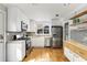 Modern kitchen with stainless steel appliances, hardwood floors, and ample storage at 966 Tilden Nw St, Atlanta, GA 30318