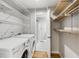 Well-organized laundry room features modern washer and dryer plus wire and wood shelving at 966 Tilden Nw St, Atlanta, GA 30318