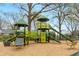 Community playground with play structures and bench seating on wood chip ground cover at 966 Tilden Nw St, Atlanta, GA 30318
