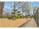 Community playground with play structures, wood chip ground cover, and bordering sidewalk at 966 Tilden Nw St, Atlanta, GA 30318
