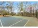 Outdoor tennis court in a park with mature trees and a fenced perimeter at 966 Tilden Nw St, Atlanta, GA 30318