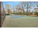 Outdoor tennis court near a playground in a fenced park with mature trees at 966 Tilden Nw St, Atlanta, GA 30318