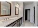 A bathroom showcases double sinks, dark wood cabinets, tiled floors, a walk-in shower, and recessed lighting at 1273 Harvest Park Ln, Suwanee, GA 30024