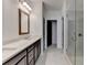 Bathroom featuring a double sink vanity with dark wood cabinets and a tiled walk-in shower at 1273 Harvest Park Ln, Suwanee, GA 30024
