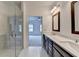 This bathroom boasts double sinks, under-sink cabinets, tiled floors and a glass enclosed walk-in shower at 1273 Harvest Park Ln, Suwanee, GA 30024