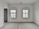 Bedroom featuring neutral carpet, trim and paint, and lots of natural light from two large windows at 1273 Harvest Park Ln, Suwanee, GA 30024