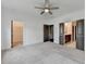This bedroom has a ceiling fan and access to a walk-in closet and the attached bathroom at 1273 Harvest Park Ln, Suwanee, GA 30024