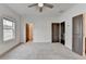 Bright bedroom boasts neutral carpet, a ceiling fan, and access to a walk-in closet and other rooms at 1273 Harvest Park Ln, Suwanee, GA 30024