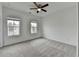 Bright, spacious bedroom with plush carpeting and large windows offering neighborhood views at 1273 Harvest Park Ln, Suwanee, GA 30024