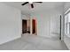 Bedroom featuring soft carpet, multiple doorways, and a window offering neighborhood views at 1273 Harvest Park Ln, Suwanee, GA 30024