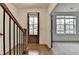 Welcoming entryway with hardwood floors, staircase, and natural light streaming through a window at 1273 Harvest Park Ln, Suwanee, GA 30024