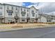 Inviting townhouse row with classic architectural details, brick accents, and a well-maintained front lawn at 1273 Harvest Park Ln, Suwanee, GA 30024