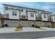 Townhome exterior featuring private decks and ground level garages at 1273 Harvest Park Ln, Suwanee, GA 30024