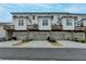 Street view of townhome exteriors showcasing private decks and garages at 1273 Harvest Park Ln, Suwanee, GA 30024