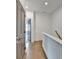 Hallway featuring hardwood floors, modern gray doors, and a white staircase at 1273 Harvest Park Ln, Suwanee, GA 30024
