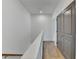 Bright hallway with hardwood floors and grey doors, creating a clean and modern aesthetic at 1273 Harvest Park Ln, Suwanee, GA 30024