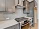 A kitchen features a stainless steel oven range, subway tile backsplash, and modern countertops at 1273 Harvest Park Ln, Suwanee, GA 30024