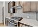 A kitchen features a stainless steel oven range, subway tile backsplash, and modern countertops at 1273 Harvest Park Ln, Suwanee, GA 30024
