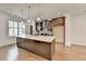 Modern kitchen featuring a large island with quartz countertops and designer pendant lighting at 1273 Harvest Park Ln, Suwanee, GA 30024