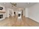 Open-concept living room with hardwood floors, fireplace, and views of kitchen and staircase at 1273 Harvest Park Ln, Suwanee, GA 30024