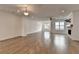 Spacious living room with wood floors, recessed lighting, and an electric fireplace with a stone surround at 1273 Harvest Park Ln, Suwanee, GA 30024