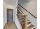 Elegant staircase with wood treads, black iron railings, and white risers, complemented by hardwood flooring at 1273 Harvest Park Ln, Suwanee, GA 30024