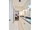 Bathroom featuring dual sinks, white cabinetry, granite countertops, tile flooring, and neutral walls at 1583 Elixir Sw Ave, Atlanta, GA 30314