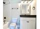 Modern bathroom featuring sleek white fixtures, gray tiling, and stylish black hardware at 1583 Elixir Sw Ave, Atlanta, GA 30314