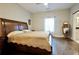 Spacious bedroom with hardwood floors, a large bed, and a full-length mirror at 1583 Elixir Sw Ave, Atlanta, GA 30314