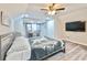 Bright bedroom with wood floors, a ceiling fan, and a mounted television at 1583 Elixir Sw Ave, Atlanta, GA 30314