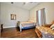 Comfortable bedroom with hardwood floors, a cozy bed, and a charming accent chair at 1583 Elixir Sw Ave, Atlanta, GA 30314