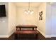 Cozy dining room showcases a wooden dining table with bench seating and a stylish light fixture at 1583 Elixir Sw Ave, Atlanta, GA 30314