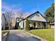 Charming two-story home with a welcoming front porch and well-manicured lawn, complemented by mature trees at 1583 Elixir Sw Ave, Atlanta, GA 30314